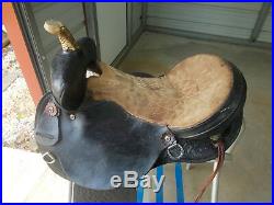 16 Black barrel saddle with tooling and a rounded skirt