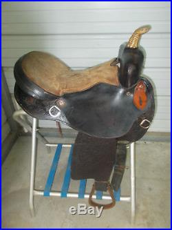 16 Black barrel saddle with tooling and a rounded skirt