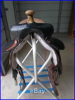 16 Black barrel saddle with tooling and a rounded skirt