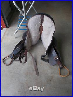 16 Black barrel saddle with tooling and a rounded skirt