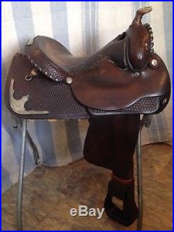 Used/vintage Circle Y 15 Western equitation saddle withsilver, tooled leather